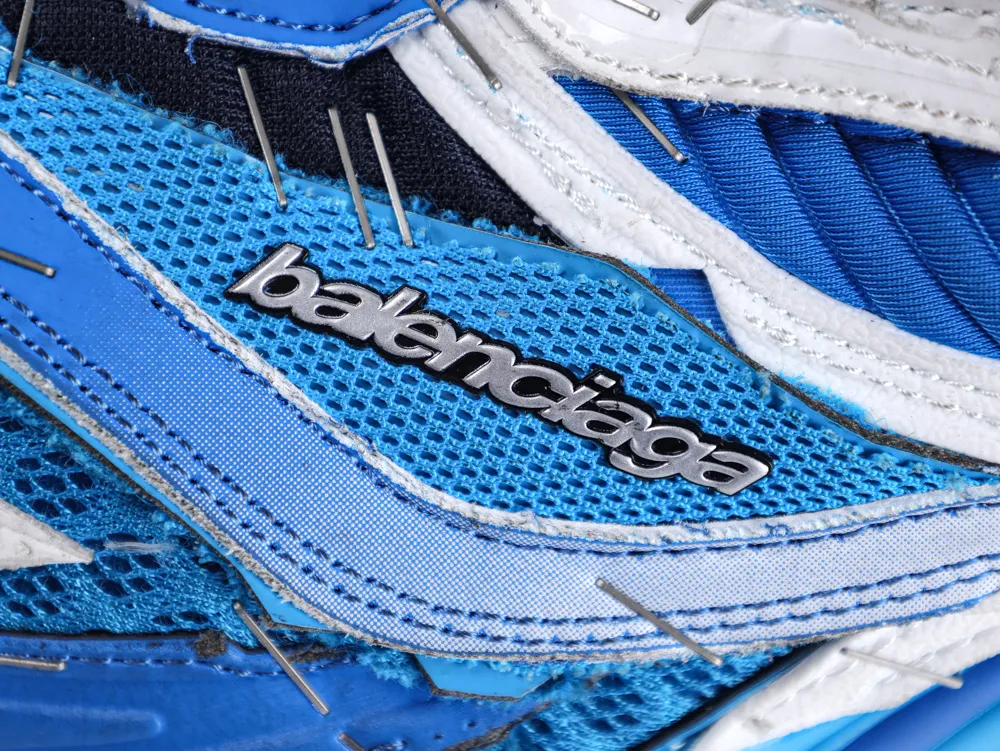 Close-up of blue and white mesh sneaker with metallic logo detail.