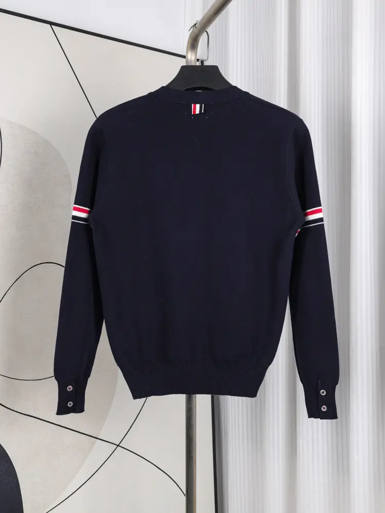 A back view of the Fine Merino Wool RWB Armband Cardigan in navy, showcasing its deep navy merino wool material and design.