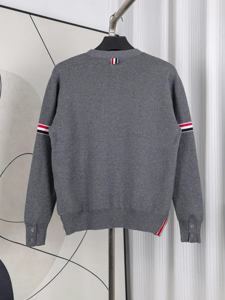 A back view of the Fine Merino Wool RWB Armband Cardigan in grey, showcasing its deep grey merino wool material and design.