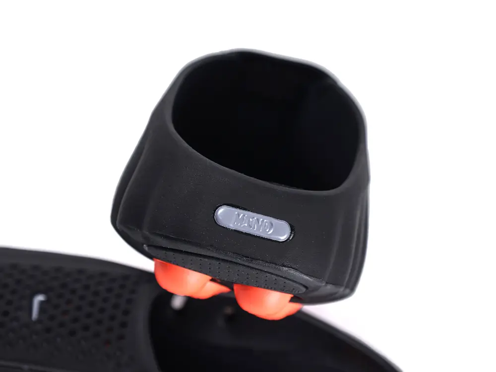 Black rubber heel part with orange elements, featuring a silver label.