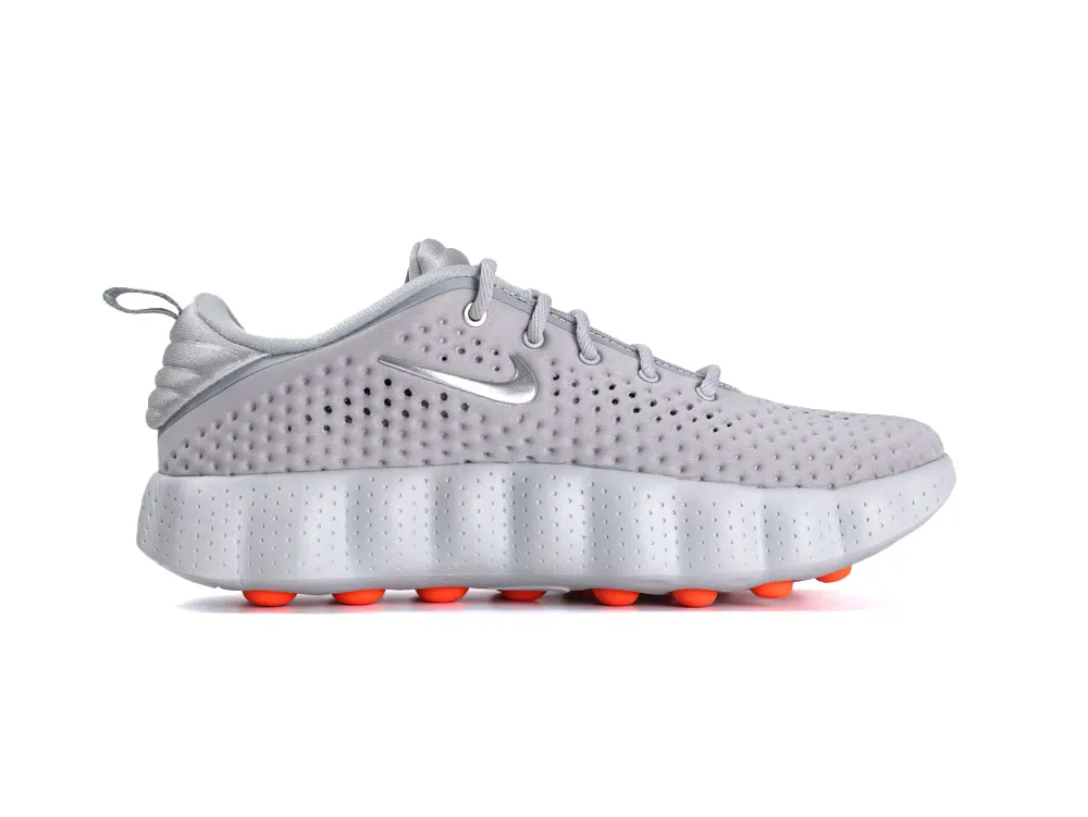 Gray mesh sneakers with perforated design, featuring vibrant orange accents on the sole.