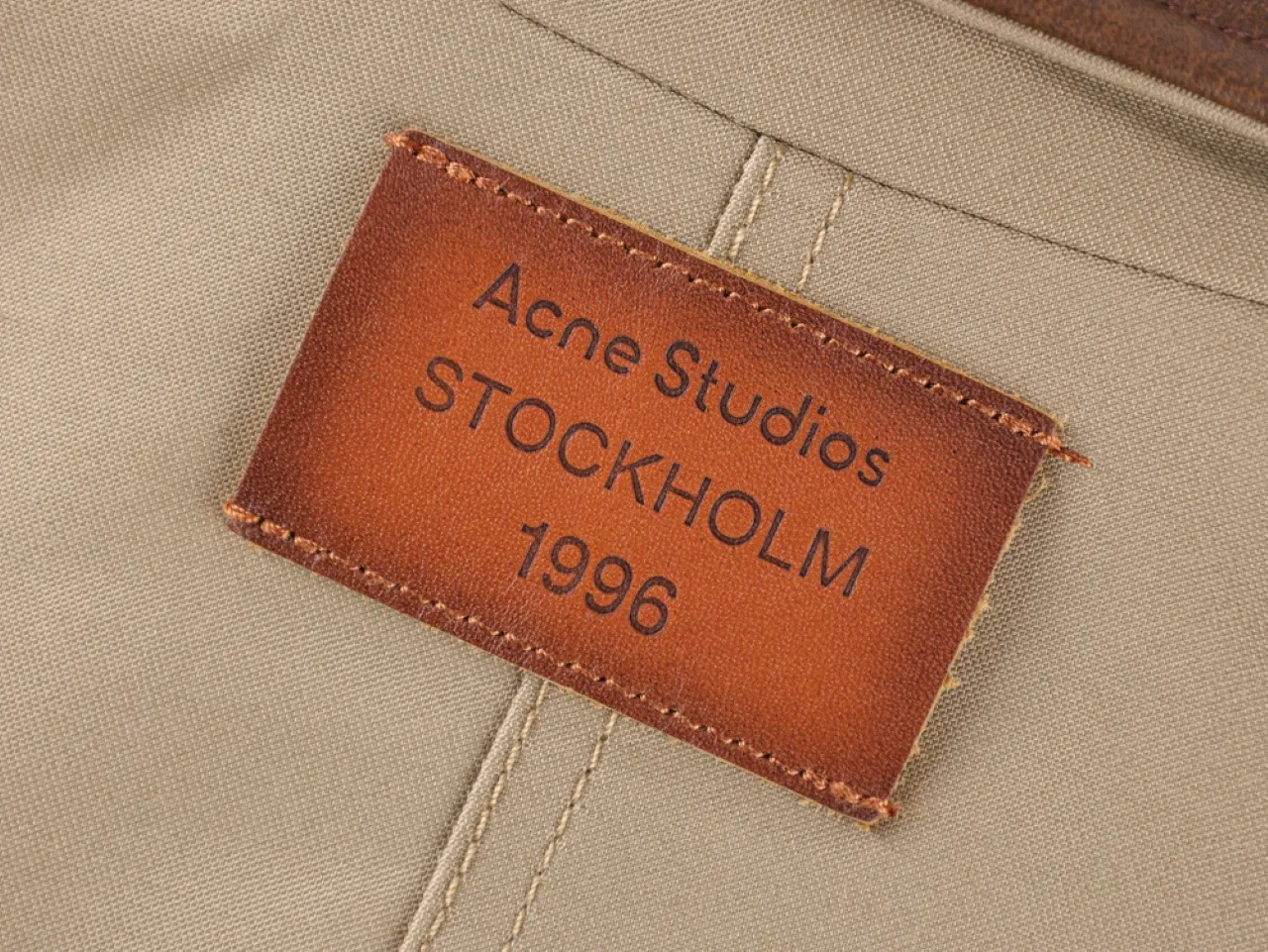 Brown leather label stitching details.