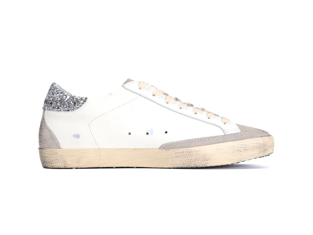 Side view of white Golden Goose Super Star sneaker with silver glitter heel
