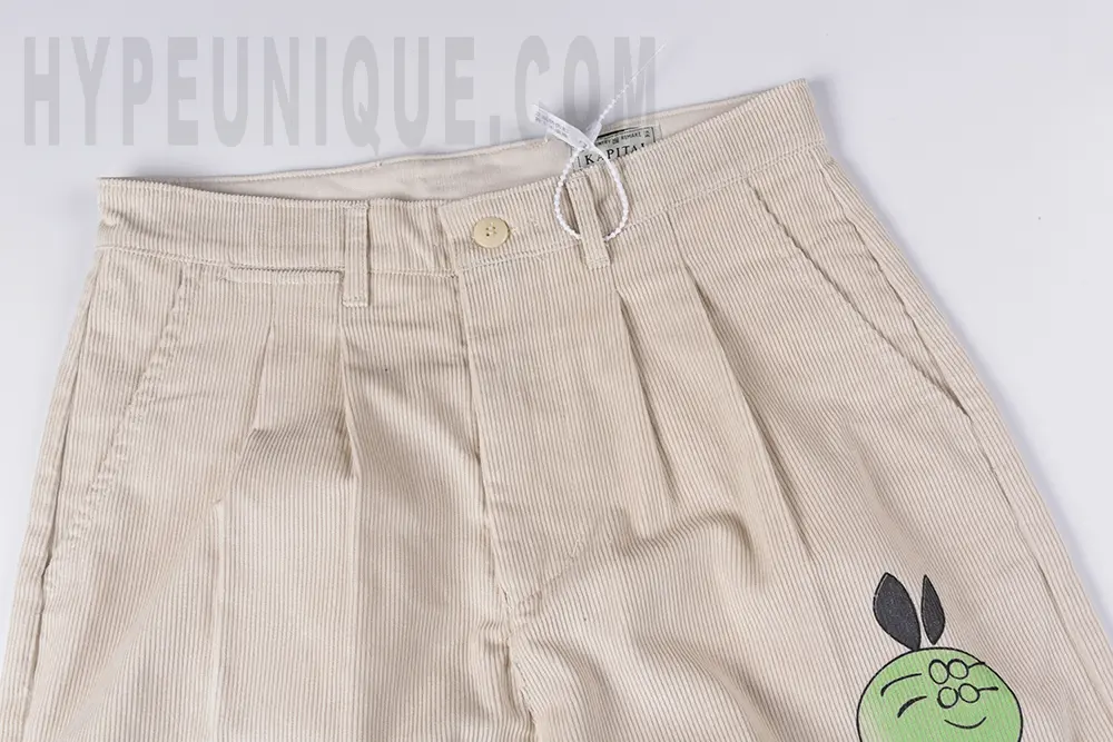 Close-up view of the crotch area on the KAPITAL Ivy Wide-Leg Pleated Printed Cotton-Corduroy Trousers.