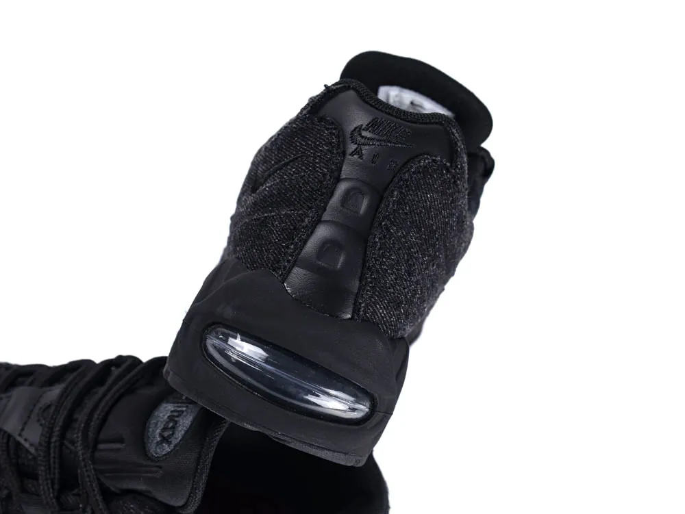 Black sneaker with synthetic and fabric material, featuring an air cushion sole.