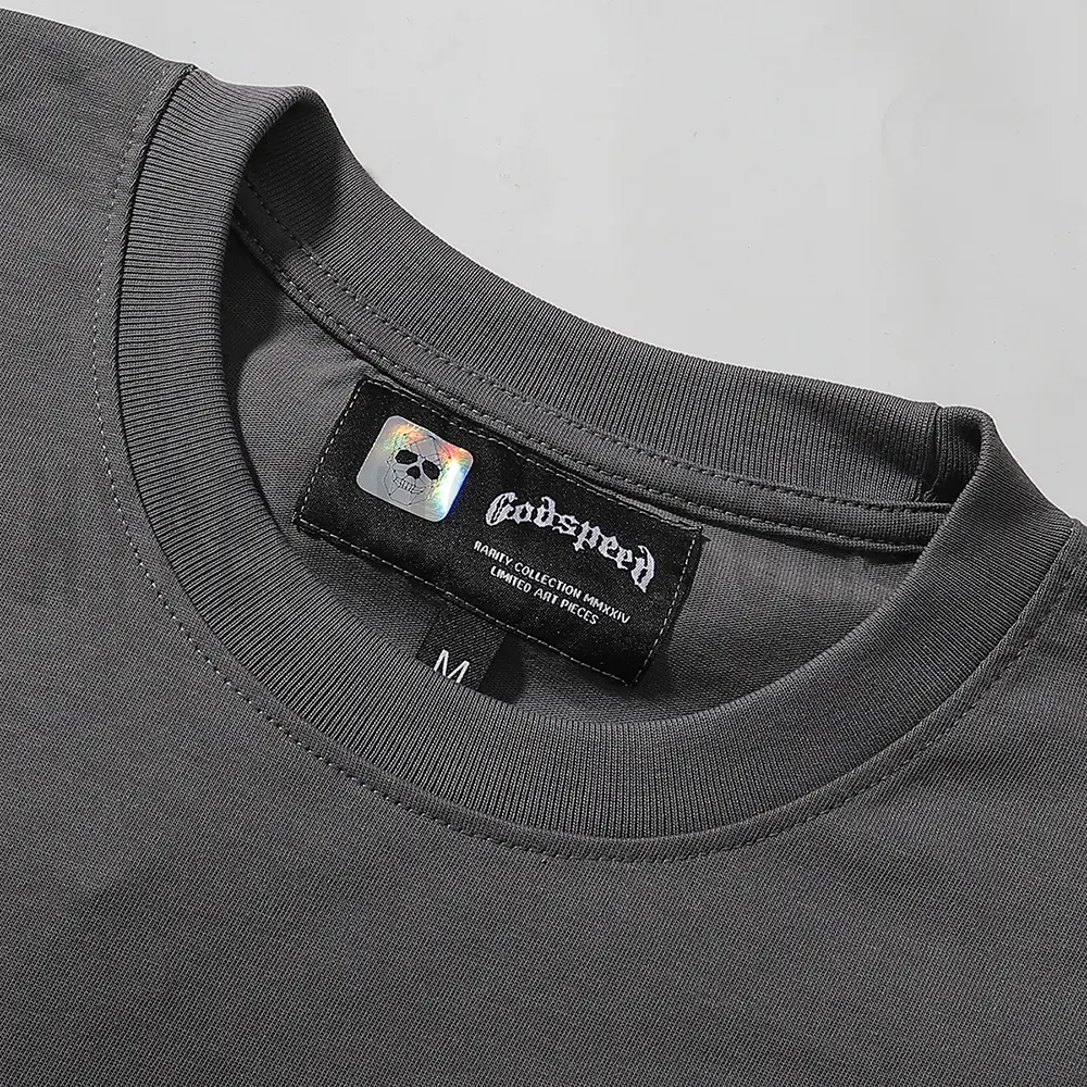 Close-up of the T-shirt's neckline tag, showcasing wash care instructions and brand details in a fashion design.