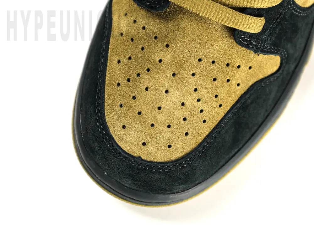 A rear-right view of the shoe's heel. Showing the black, green, and light green suede heel.
