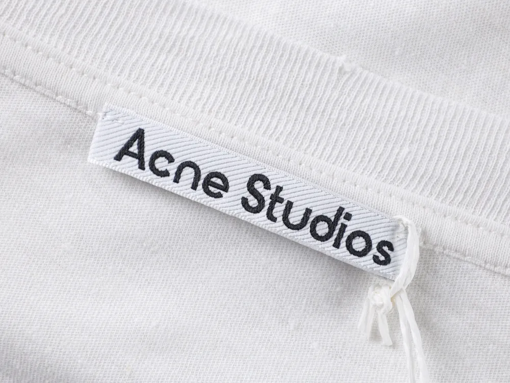 White cotton clothing tag with Acne Studios