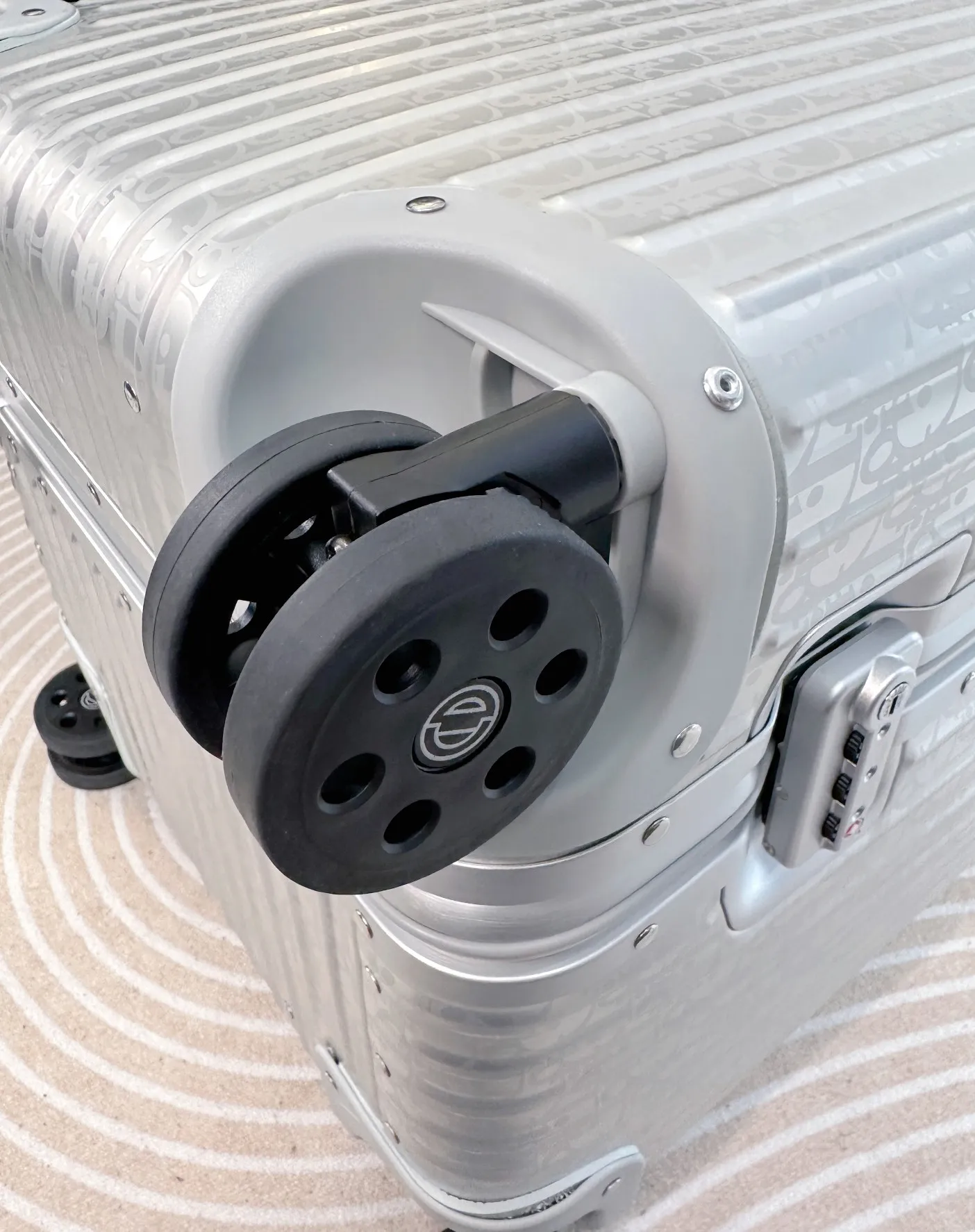 Close-up of black suitcase spinner wheel
