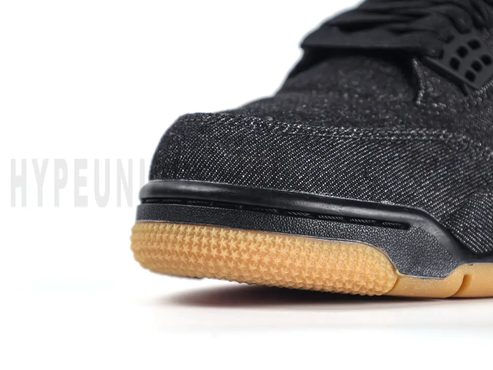 Close-up of the Levi’s tag on the Air Jordan 4 Retro Levi’s Black GS, showcasing the iconic red tab stitched into the black denim upper.