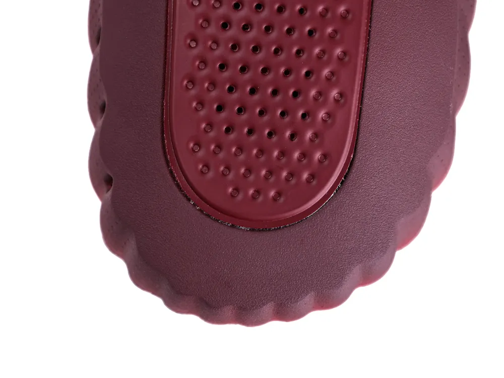 Overhead shot of the rounded burgundy toe box showing the dimpled texture and perforated patterns.