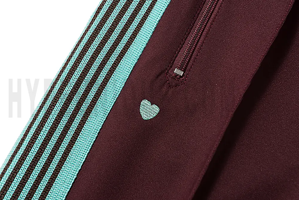 Close-up detail of the track pants pocket.