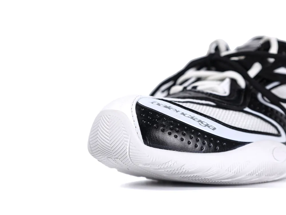 Close-up of black and white sneaker with mesh material and textured rubber sole.