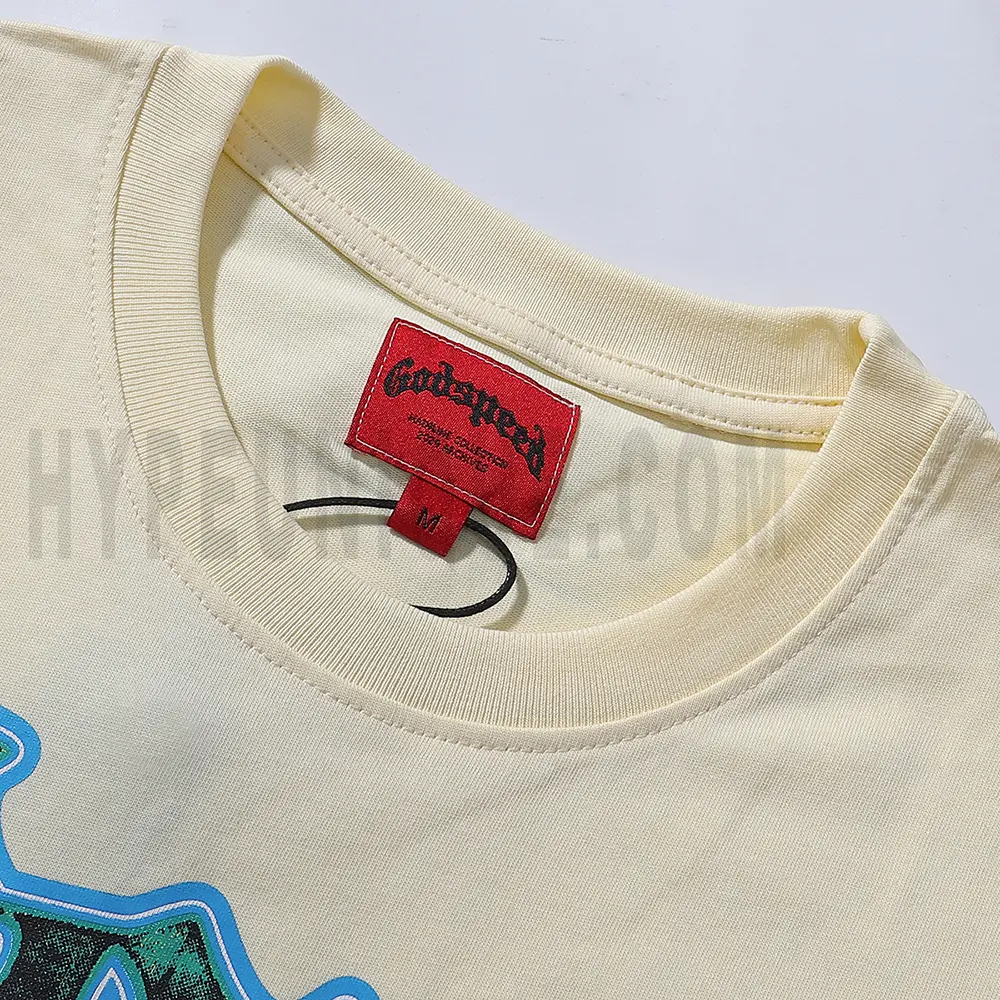 Detailed close-up of the tee's neck label, featuring wash care instructions and subtle brand branding in a clean, minimalist typography