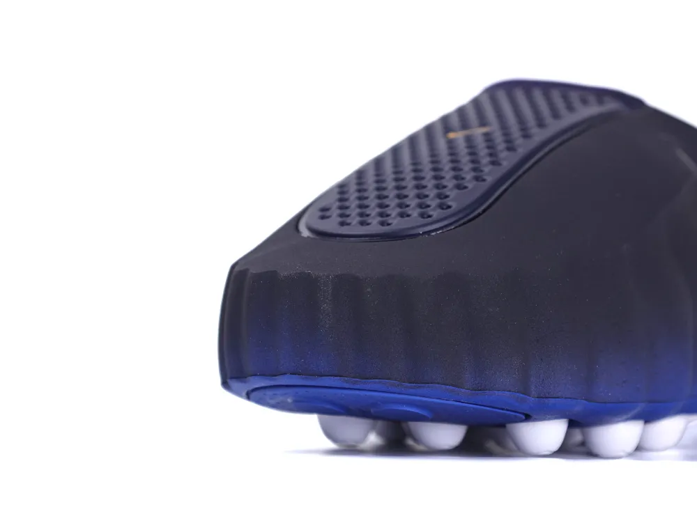 Close-up of the front of the shoe highlighting the textured navy upper and the royal blue outsole with white pods.