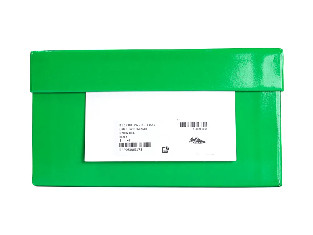 Green shoe box made of glossy material with a label attached.
