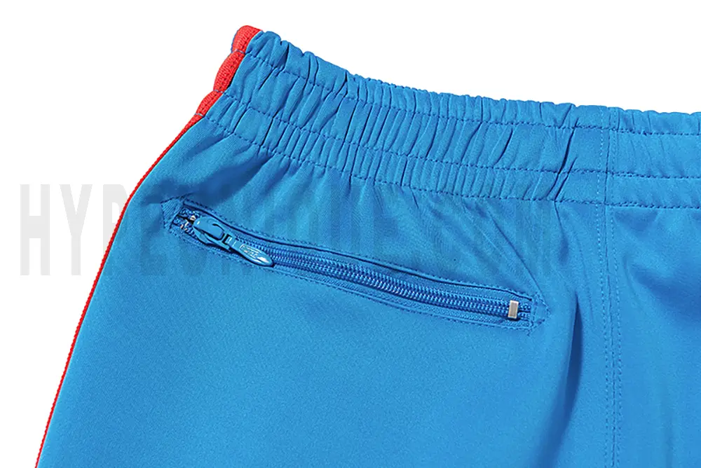 Detail of the back zip pocket on the track pants.