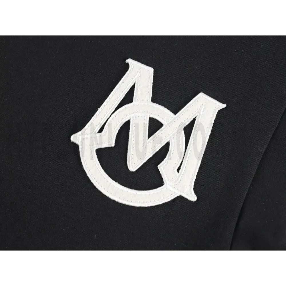 Detailed shot capturing the graphic print on the black tee's front panel.