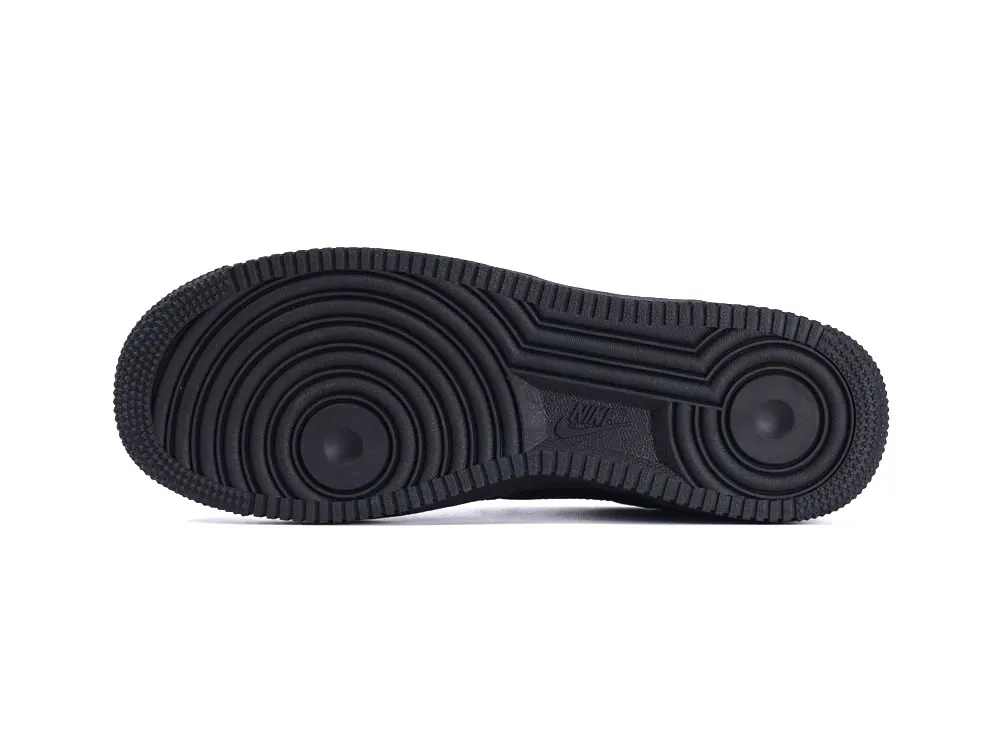 Black rubber outsole with circular patterns and textured edges for traction.