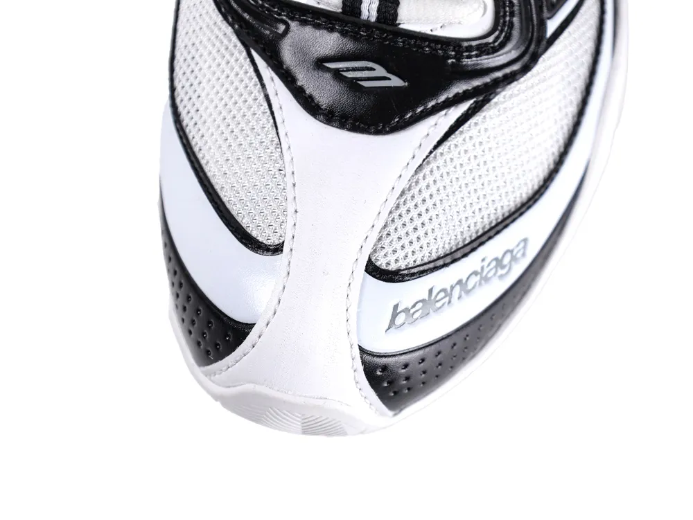 Close-up of a black and white sneaker with mesh and leather details.