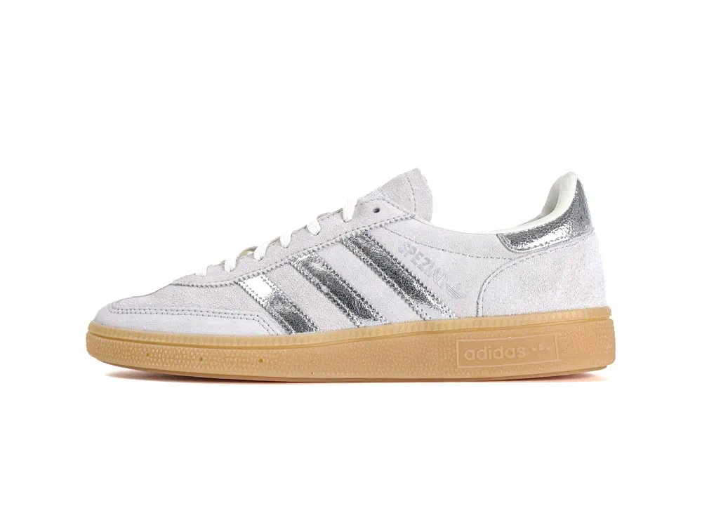 White suede sneaker with silver metallic stripes and gum rubber sole.