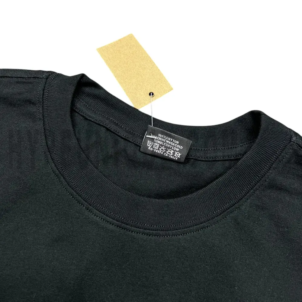 Neckline tag close-up, displaying garment care symbols and brand information with fashion-forward presentation.