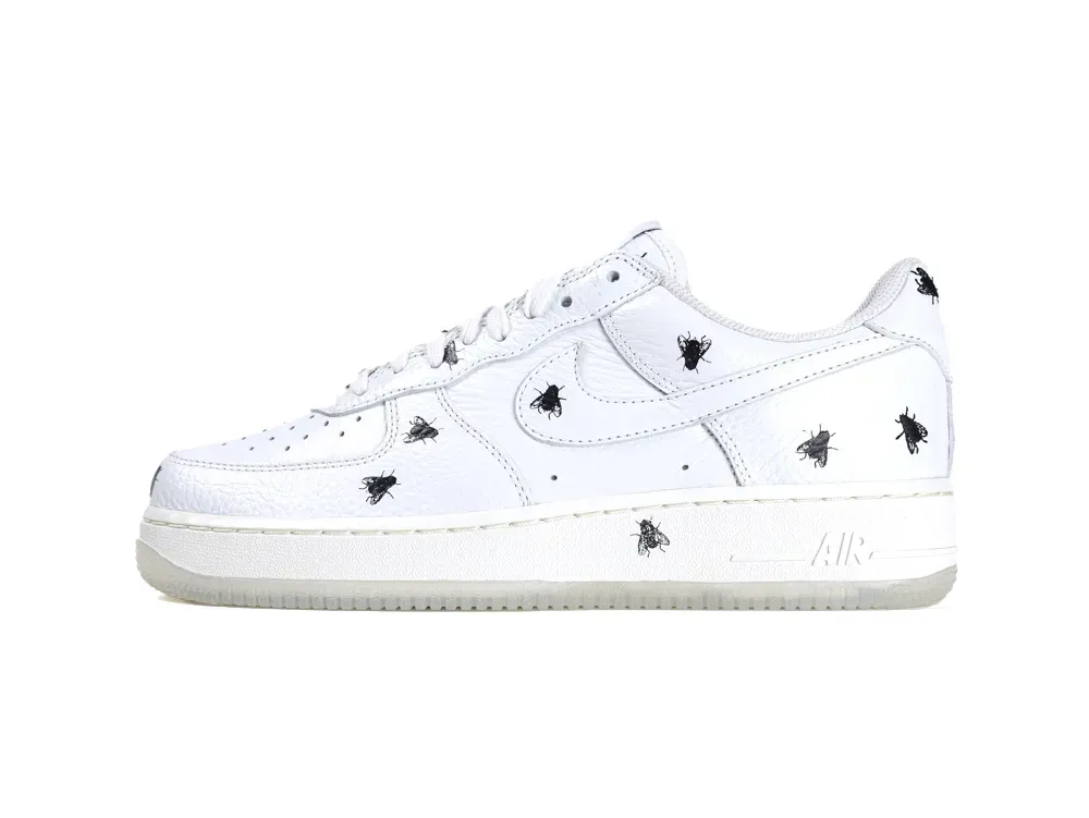 White leather sneaker with black fly print designs on the upper surface.