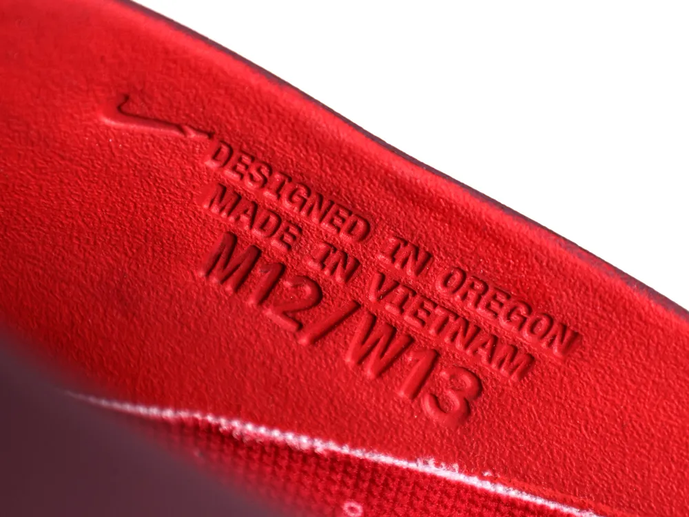 Close-up of the inner side wall with embossed text: "DESIGNED IN OREGON," "MADE IN VIETNAM," and size "M12/W13."