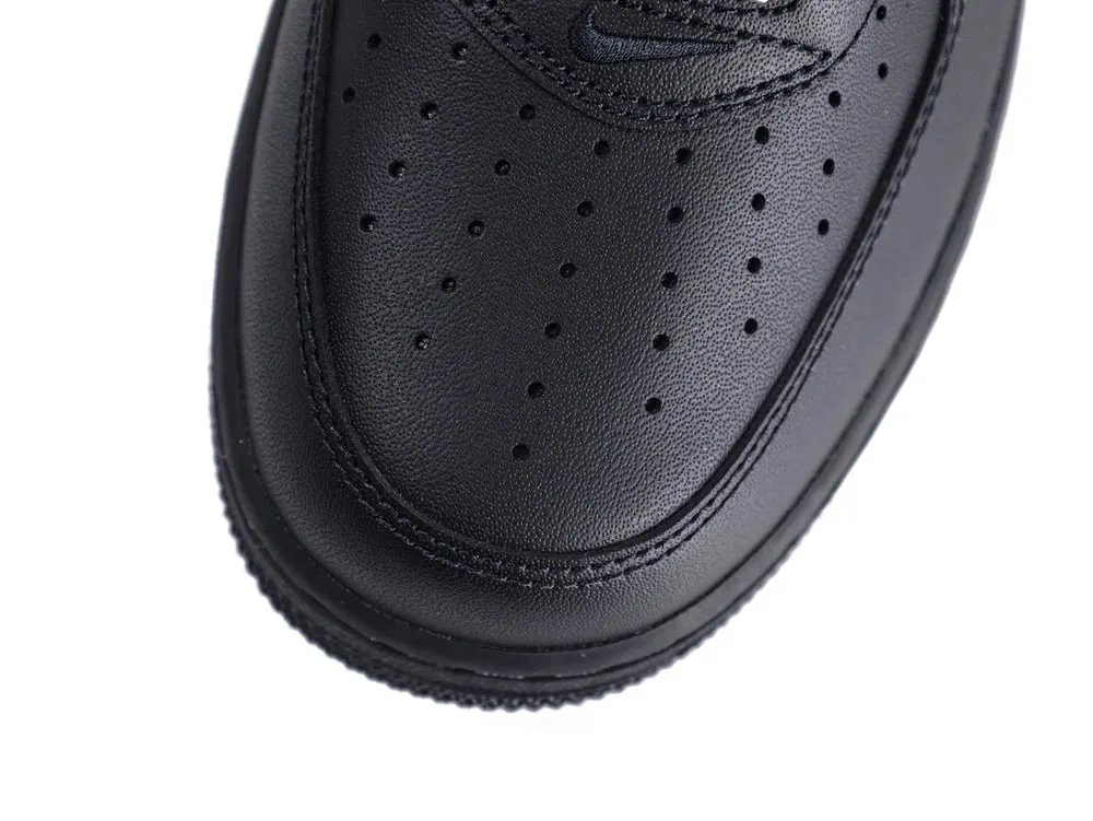 Close-up of black leather shoe toe with perforations and stitching detail.