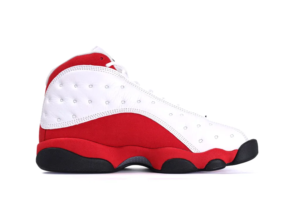 White and red leather sneaker with black sole and perforated detailing.