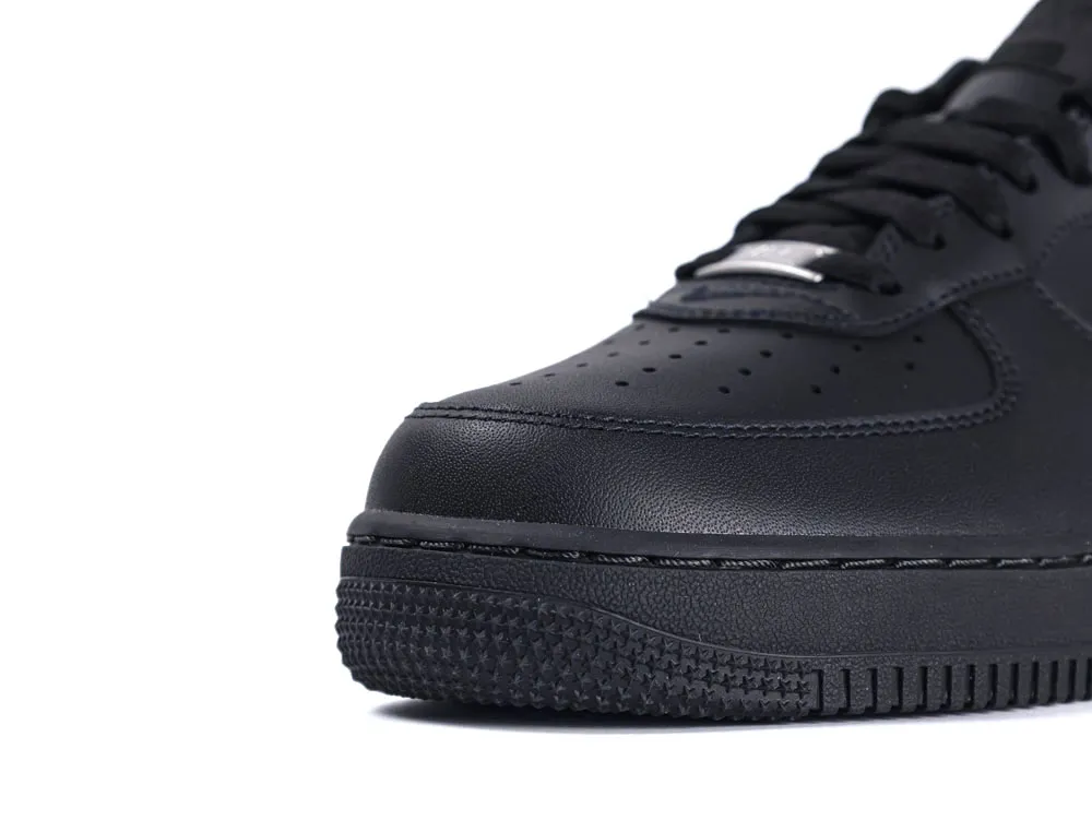 Close-up of a black leather sneaker shoe, focusing on the toe area.