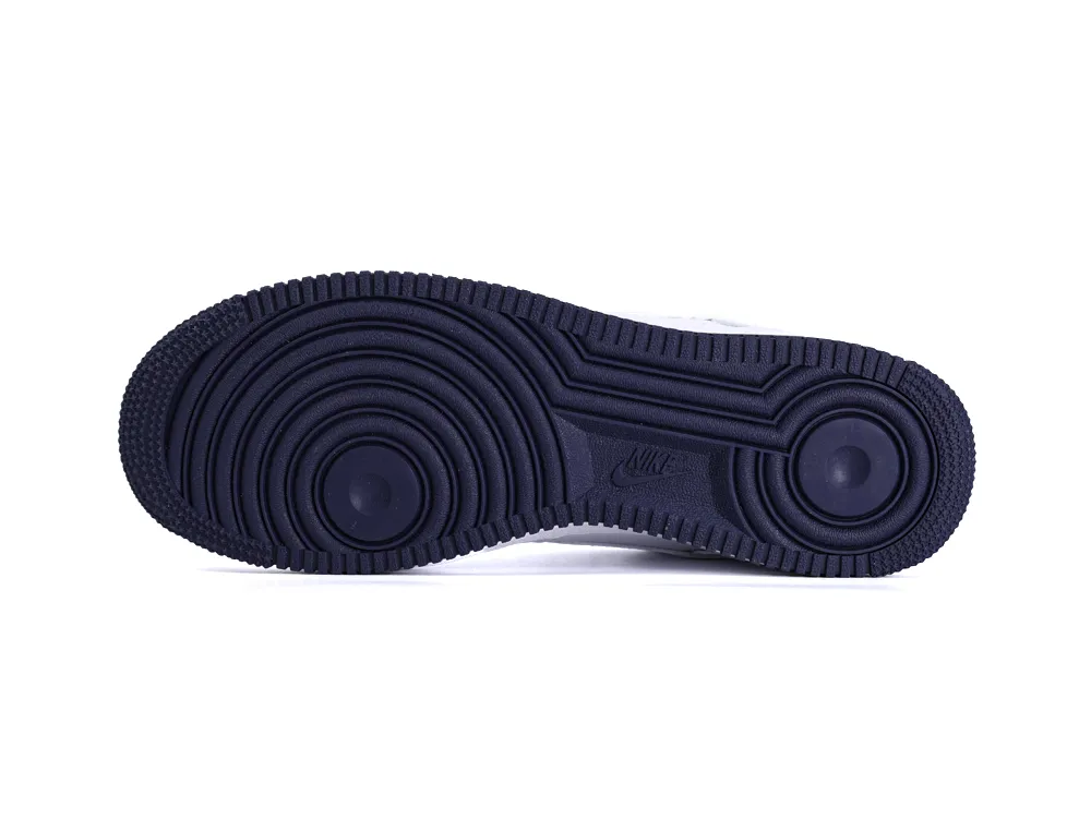 Dark blue rubber sole of a shoe with circular tread pattern and logo.