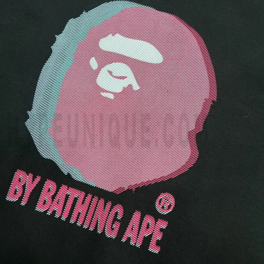Detailed shot capturing the graphic print on the black tee's front panel.