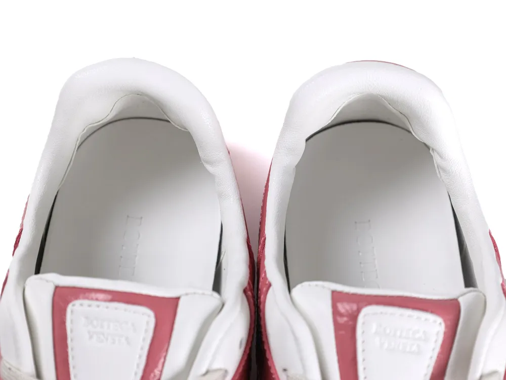 Top-down view into the sneaker opening showing the white leather lining and pink tongue details.
