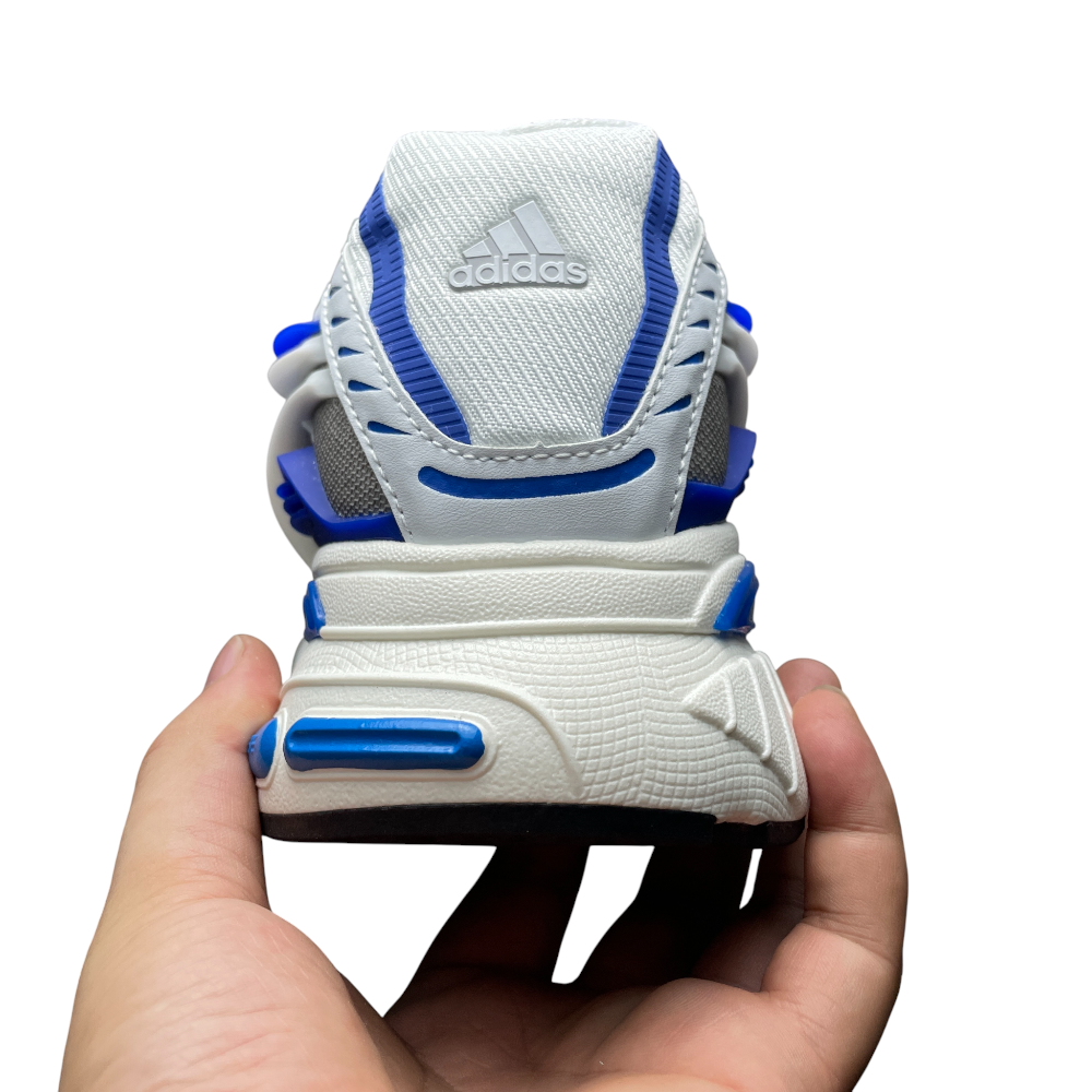 Close-up of a white sneaker with blue accents, showcasing textured material and design from a rear angle.