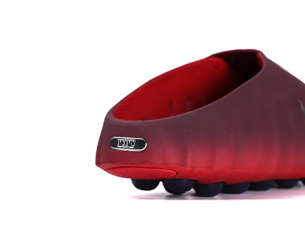 Rear view of the slip-on shoe showing the burgundy gradient upper and a small silver "MIND" badge on the heel.