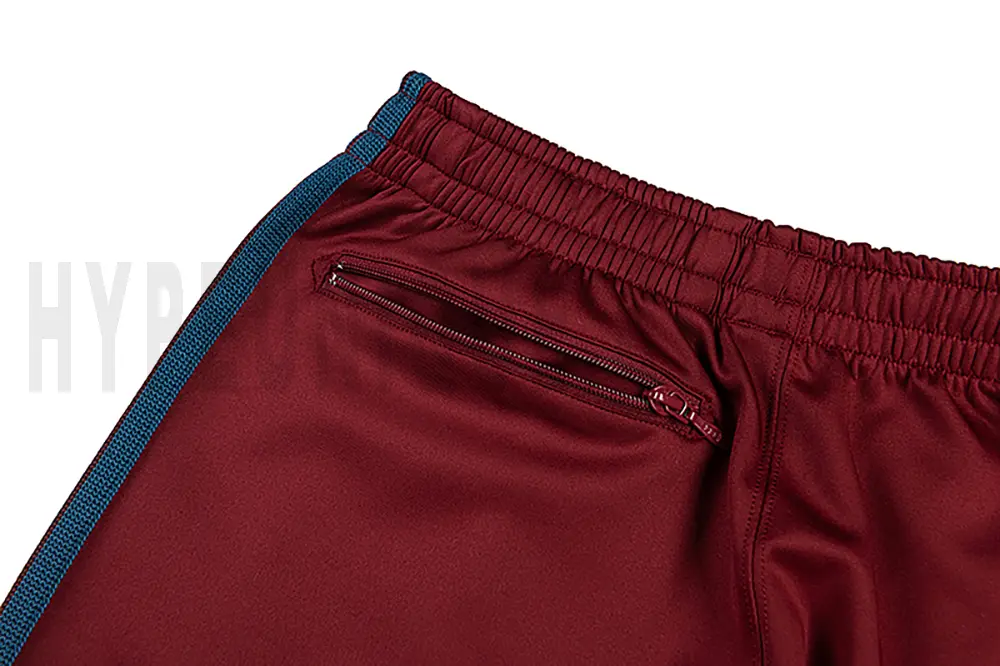 Detail of the back zip pocket on the track pants.