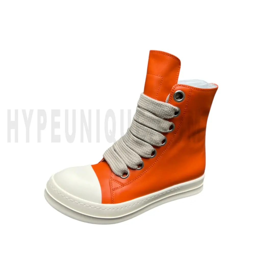 The left of the orange shoes