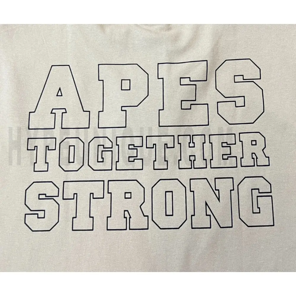 Detailed shot capturing the graphic print on the beige tee's back panel.