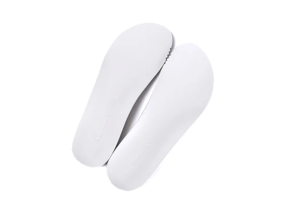 Pair of plain white removable insoles with the Bottega Veneta brand name embossed at the heel.