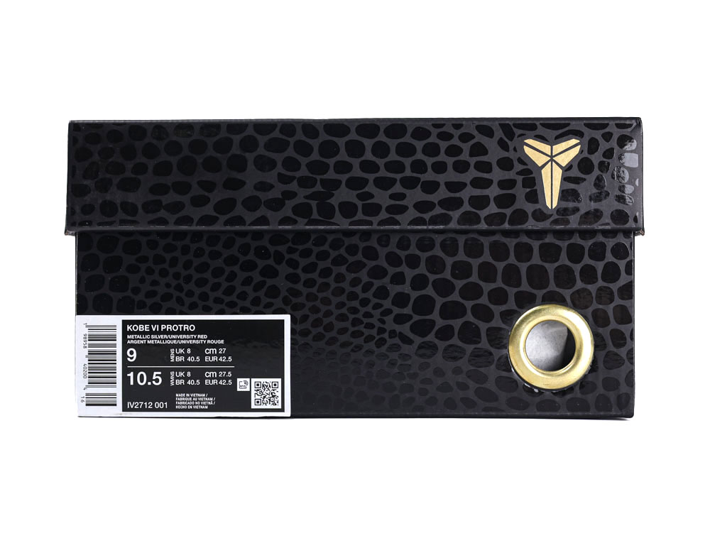 Black patterned shoe box with gold logo and metal eyelet detail.
