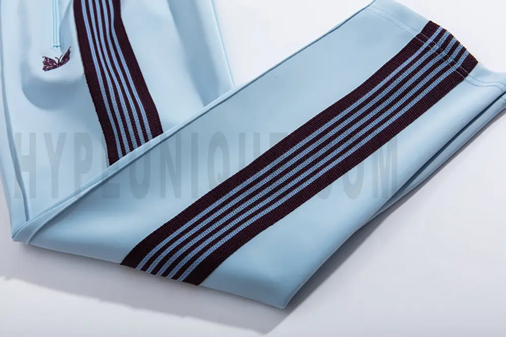Side stripe detailing on blue pants.