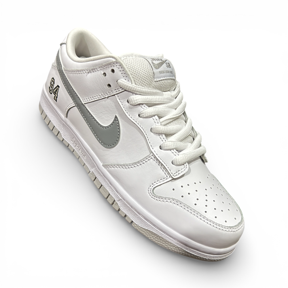Three-quarter angle view of white low-top sneaker highlighting overall shape and silver swoosh detail