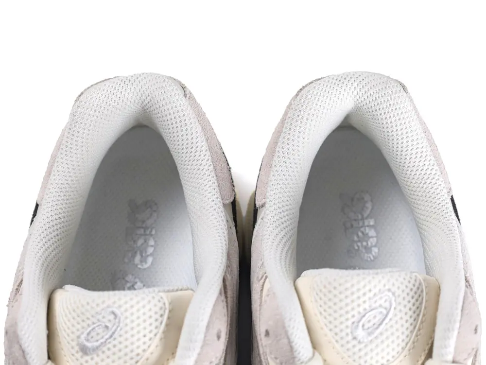 White and beige mesh sneakers featuring the heel and collar area.