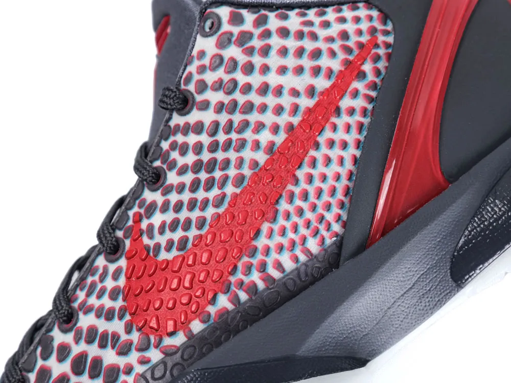Close-up of red and gray patterned sneaker, featuring textured material and distinctive logo design.