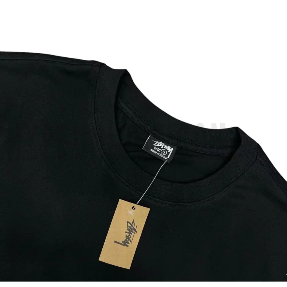 Neckline tag close-up, displaying garment care symbols and brand information with fashion-forward presentation.