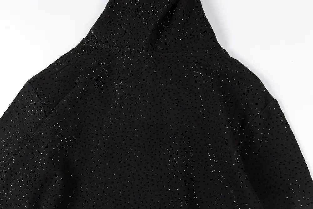 A detailed rear view of the Sp5der VVS Hoodie in Black, showcasing the cotton fabric and rhinestone craftsmanship.